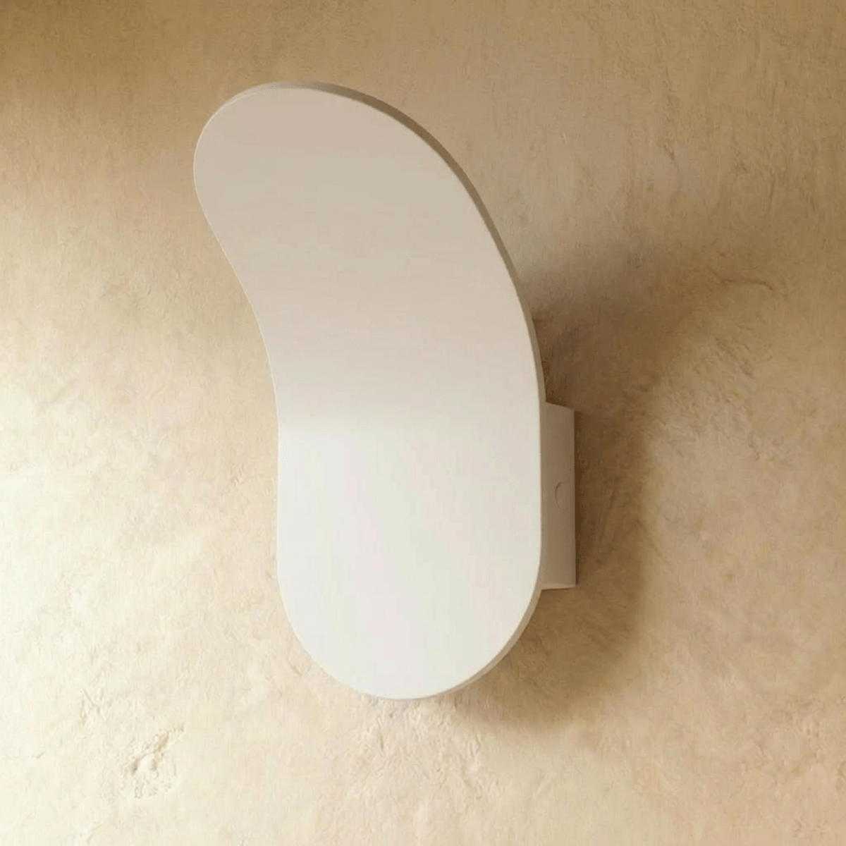 Fana Wall Lamp by Residence Supply mounted on a wall, featuring a sleek design with a white shade and metal arm for modern lighting.