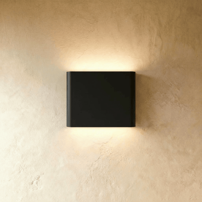 Femi Wall Lamp by Residence Supply showing a modern black wall-mounted light fixture with a sleek design.
