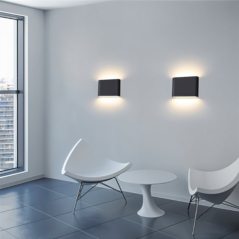 Femi Wall Lamp by Residence Supply mounted on a wall, featuring a sleek modern design with a white shade and metal arm.