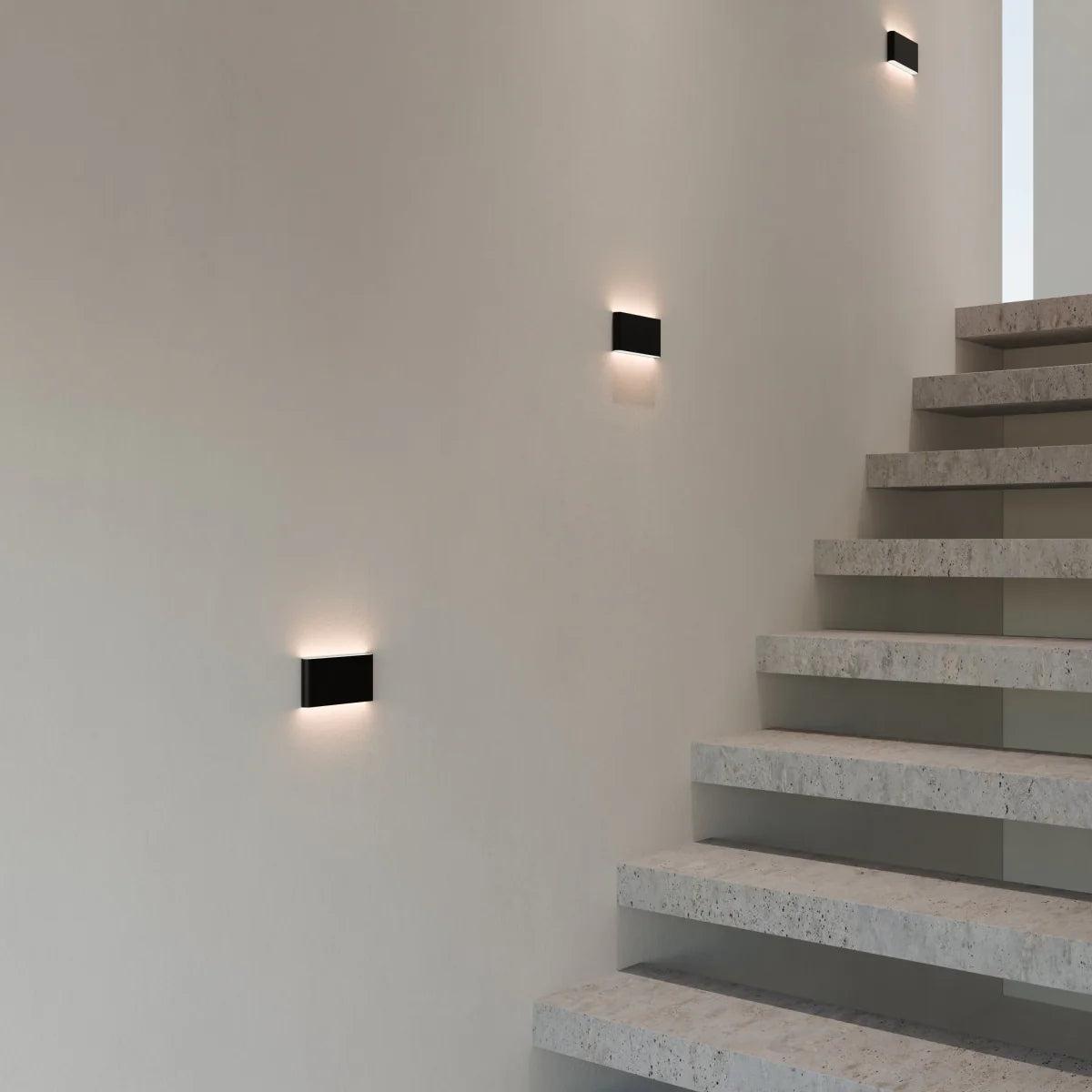 Femi wall lamp by Residence Supply mounted on a wall with a sleek modern design and warm ambient lighting.