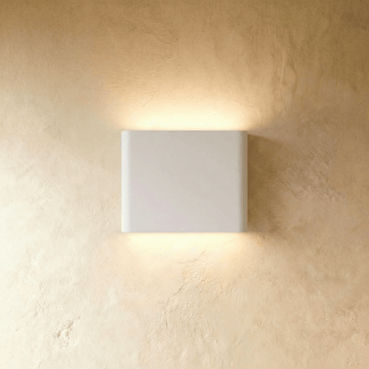 Femi Wall Lamp by Residence Supply featuring modern design with sleek metal finish and adjustable arm for ambient lighting.