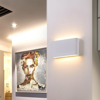 Femi wall lamp by Residence Supply with a modern design and sleek metal finish mounted on a wall.
