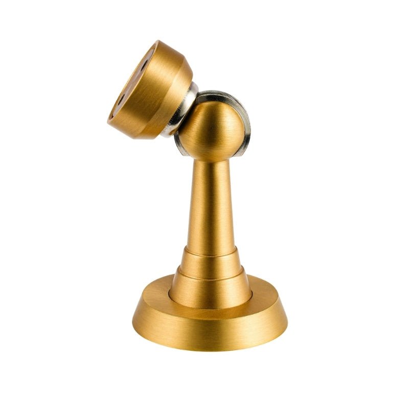 Brushed gold Figal magnetic door stop from Residence Supply, mounted on a door to prevent it from closing fully.