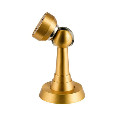 Brushed gold Figal magnetic door stop from Residence Supply, mounted on a door to prevent it from closing fully.