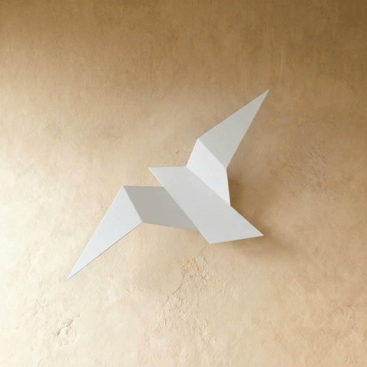 Residence Supply Finch Wall Lamp mounted on a wall with a sleek, modern design and metallic finish.
