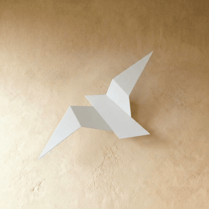 Residence Supply Finch Wall Lamp mounted on a wall with a sleek, modern design and metallic finish.
