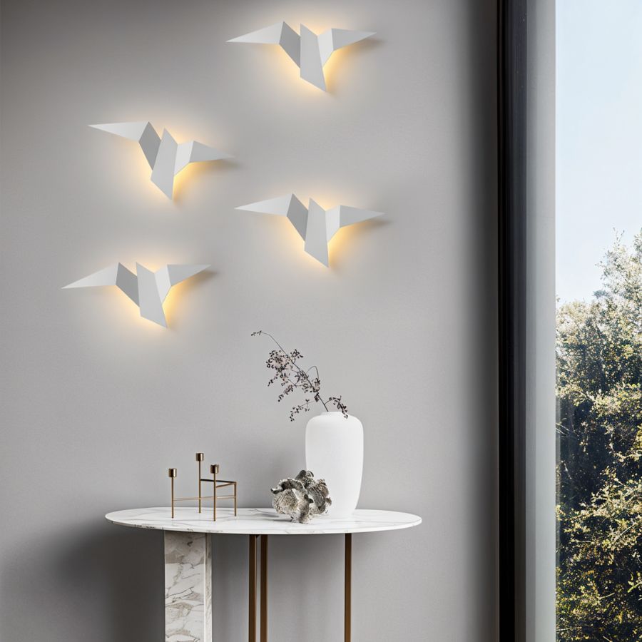 Residence Supply Finch Wall Lamp mounted on a wall, featuring a sleek, modern design with a curved metal arm and adjustable shade.