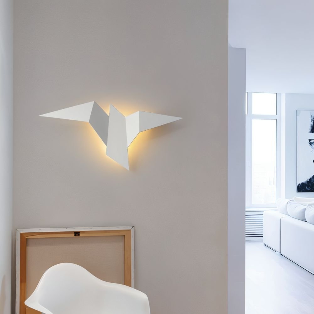 Residence Supply Finch Wall Lamp mounted on a wall with a sleek, modern design and metal finish, providing stylish ambient lighting.