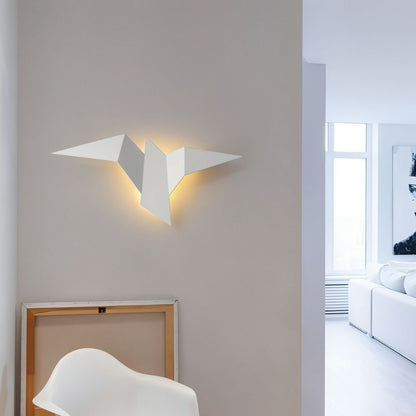 Residence Supply Finch Wall Lamp mounted on a wall with a sleek, modern design and metal finish, providing stylish ambient lighting.