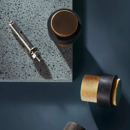 Residence Supply Finio door stop mounted on wall, sleek metal door hardware for preventing door damage in home and garden.