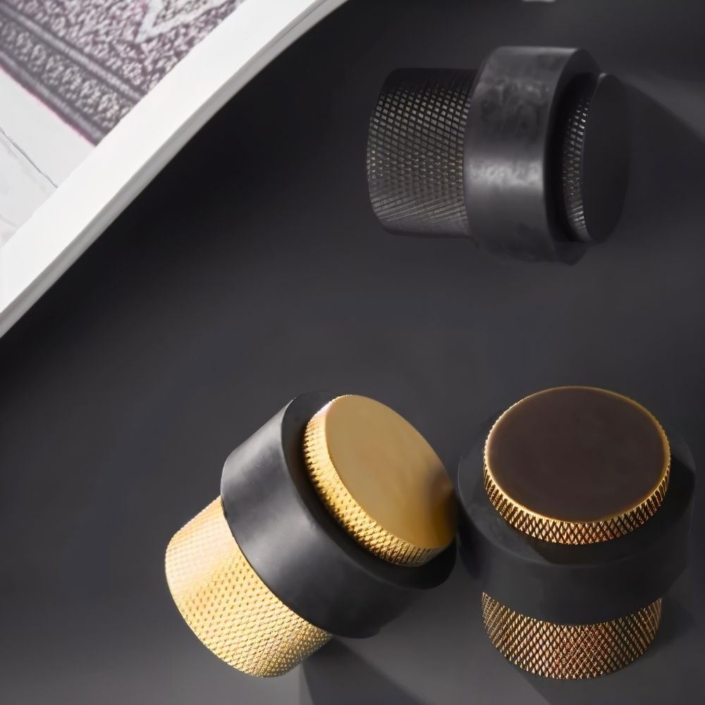 Residence Supply Finio door stop on a hardwood floor, designed to prevent door movement and protect walls.