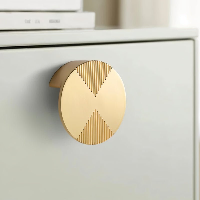 Close-up of a brass Flict Knob by Residence Supply, a geometric cabinet hardware knob for home and garden furniture.