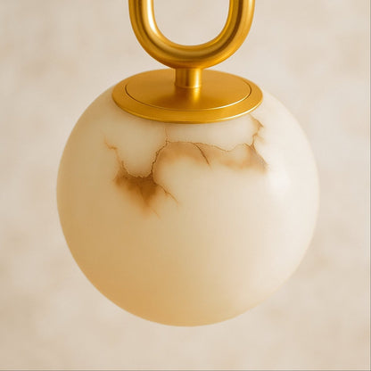 Alabaster pendant light by Residence Supply featuring a smooth, rounded gong-shaped design hanging from a ceiling mount.