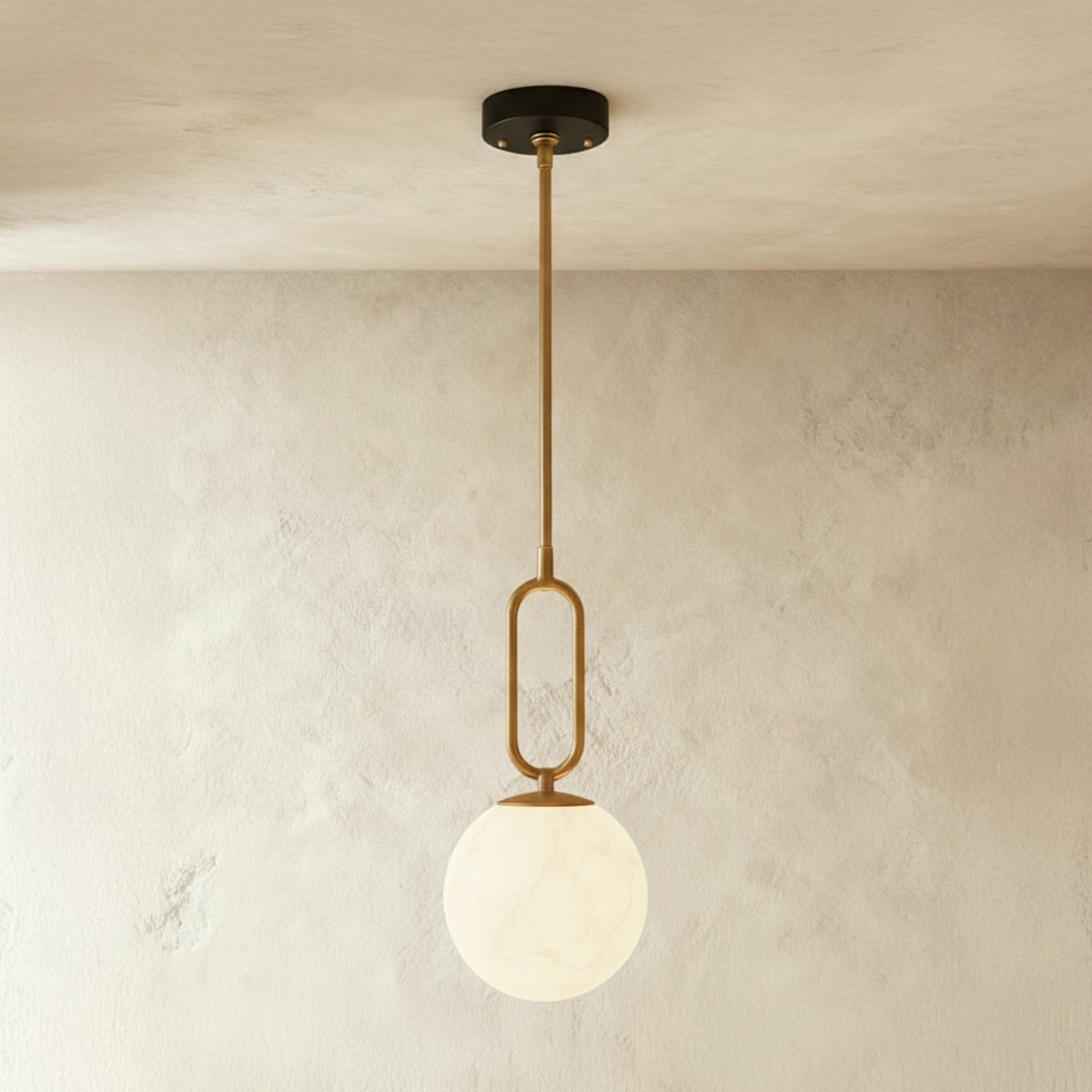 Alabaster pendant light by Residence Supply featuring a smooth, rounded gong shape and warm, diffused lighting.