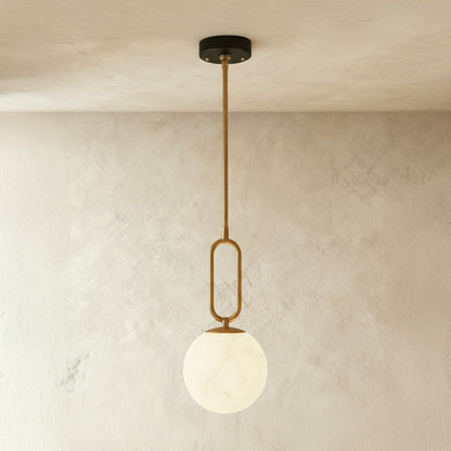 Alabaster pendant light by Residence Supply featuring a smooth, rounded gong shape and warm, diffused lighting.