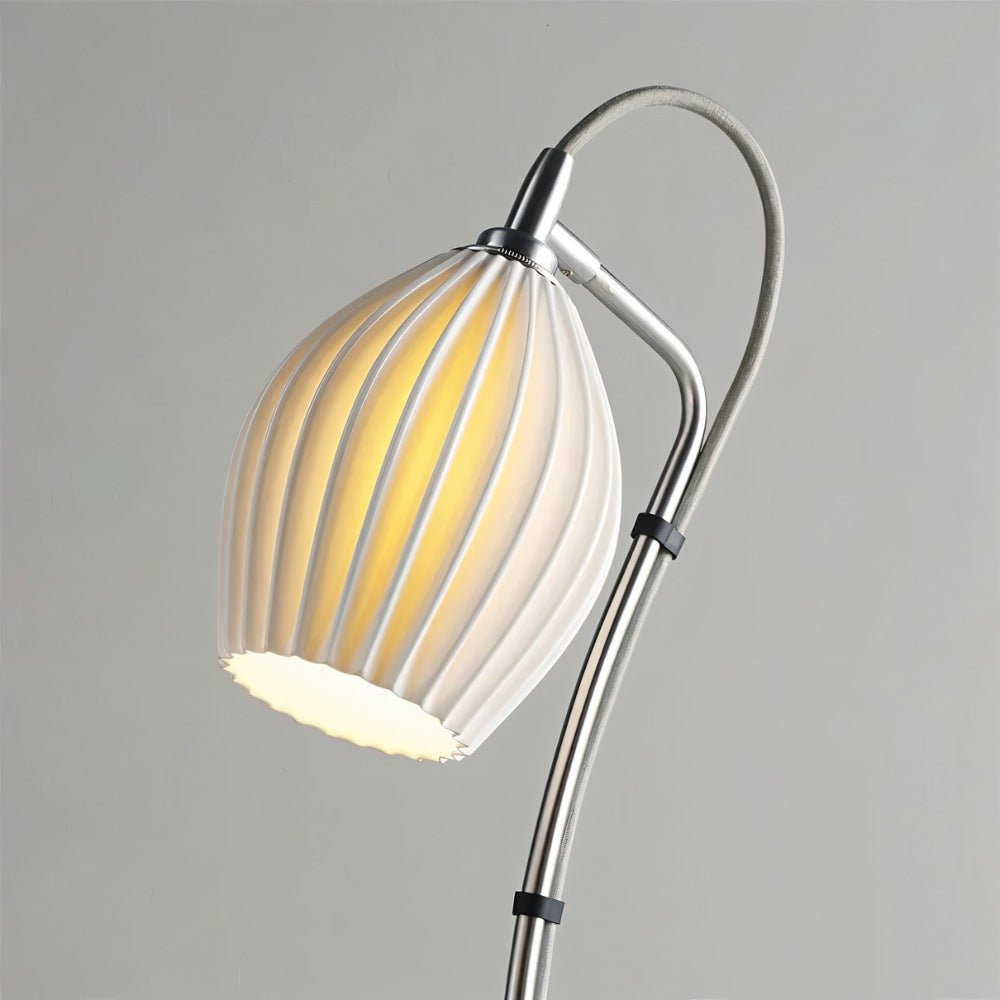 Haela table lamp by Residence Supply with a sleek modern design and a neutral-colored fabric lampshade on a wooden base.