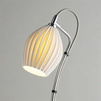 Haela table lamp by Residence Supply with a sleek modern design and a neutral-colored fabric lampshade on a wooden base.
