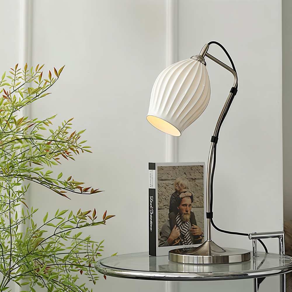 Haela table lamp by Residence Supply featuring a modern design with a sleek base and a soft fabric lampshade on a wooden table