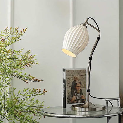 Haela table lamp by Residence Supply featuring a modern design with a sleek base and a soft fabric lampshade on a wooden table