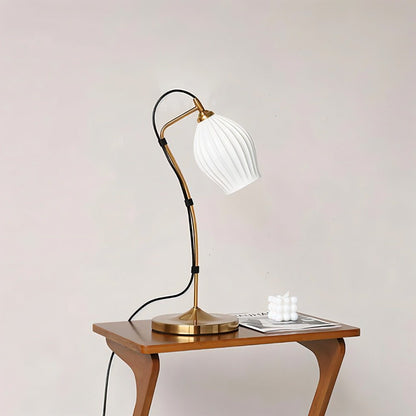 Haela Table Lamp by Residence Supply with a modern design, featuring a sleek base and a fabric lampshade on a wooden side table.
