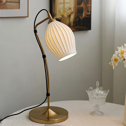 Haela Table Lamp by Residence Supply with a modern ceramic base and fabric lampshade on a wooden side table.