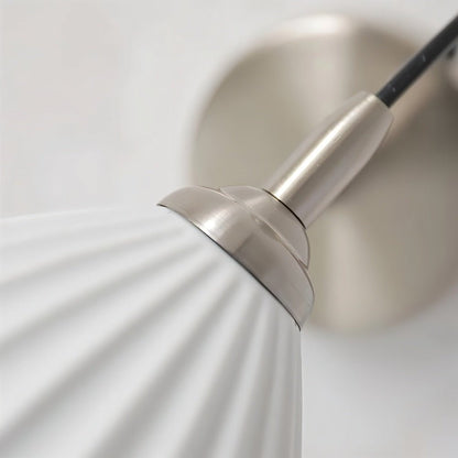 Modern Haela Wall Lamp by Residence Supply featuring a sleek design with a curved metal arm and a round shade for stylish lighting.