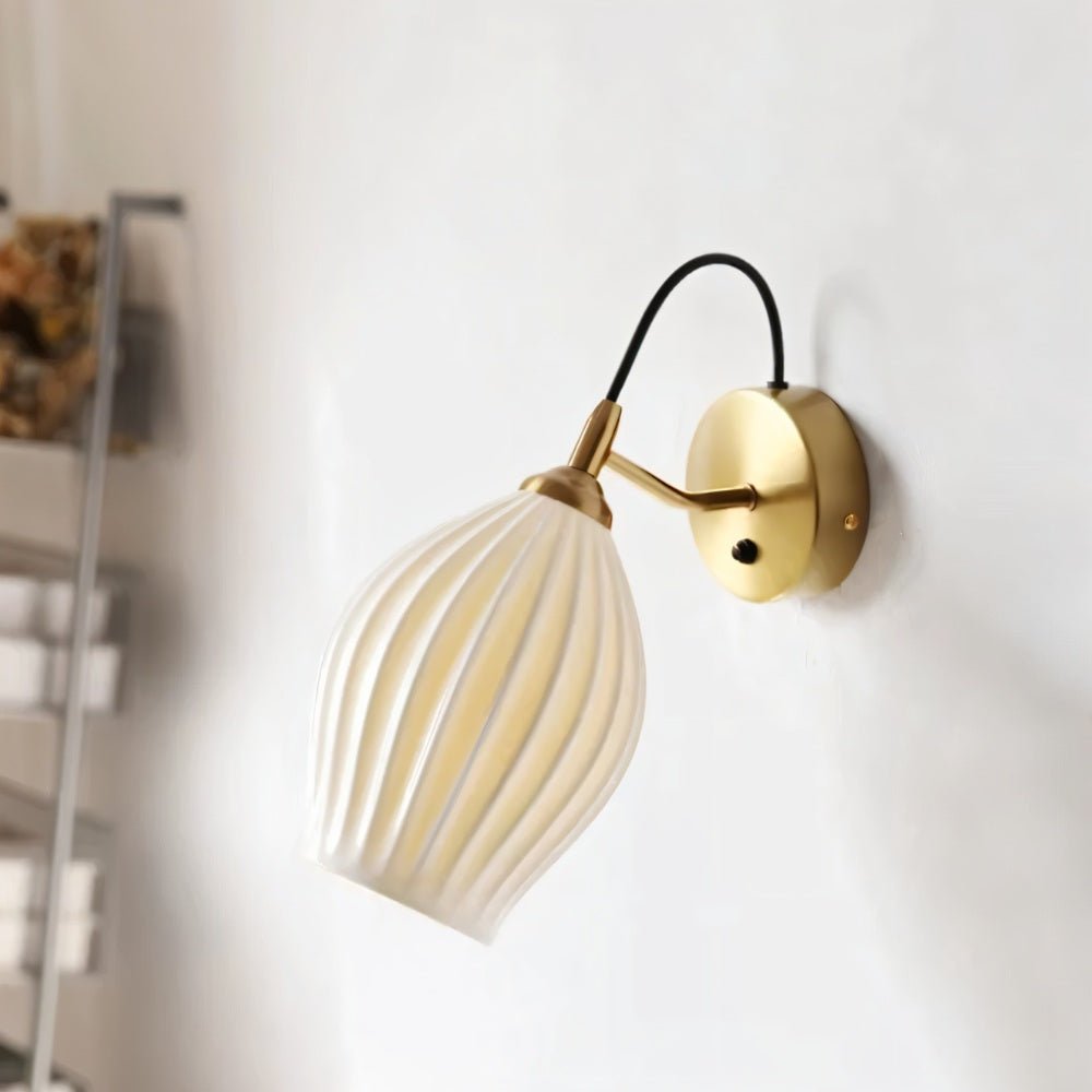 Modern Haela Wall Lamp by Residence Supply, featuring a sleek design with a curved metallic arm and a round lampshade.