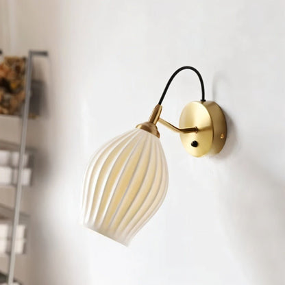 Modern Haela Wall Lamp by Residence Supply, featuring a sleek design with a curved metallic arm and a round lampshade.