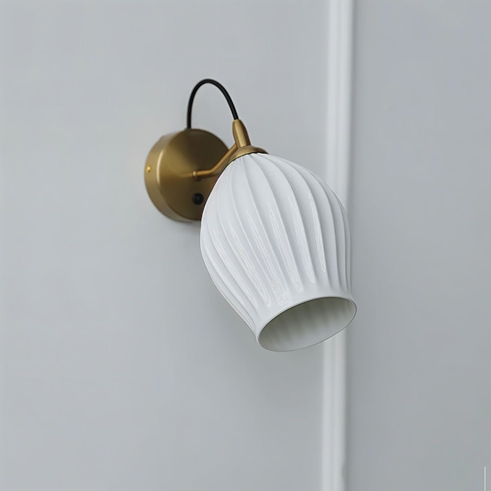 Modern Haela Wall Lamp by Residence Supply featuring a sleek design and brushed metal finish mounted on a wall.
