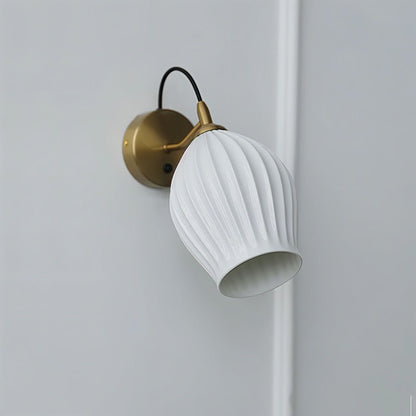 Modern Haela Wall Lamp by Residence Supply featuring a sleek design and brushed metal finish mounted on a wall.