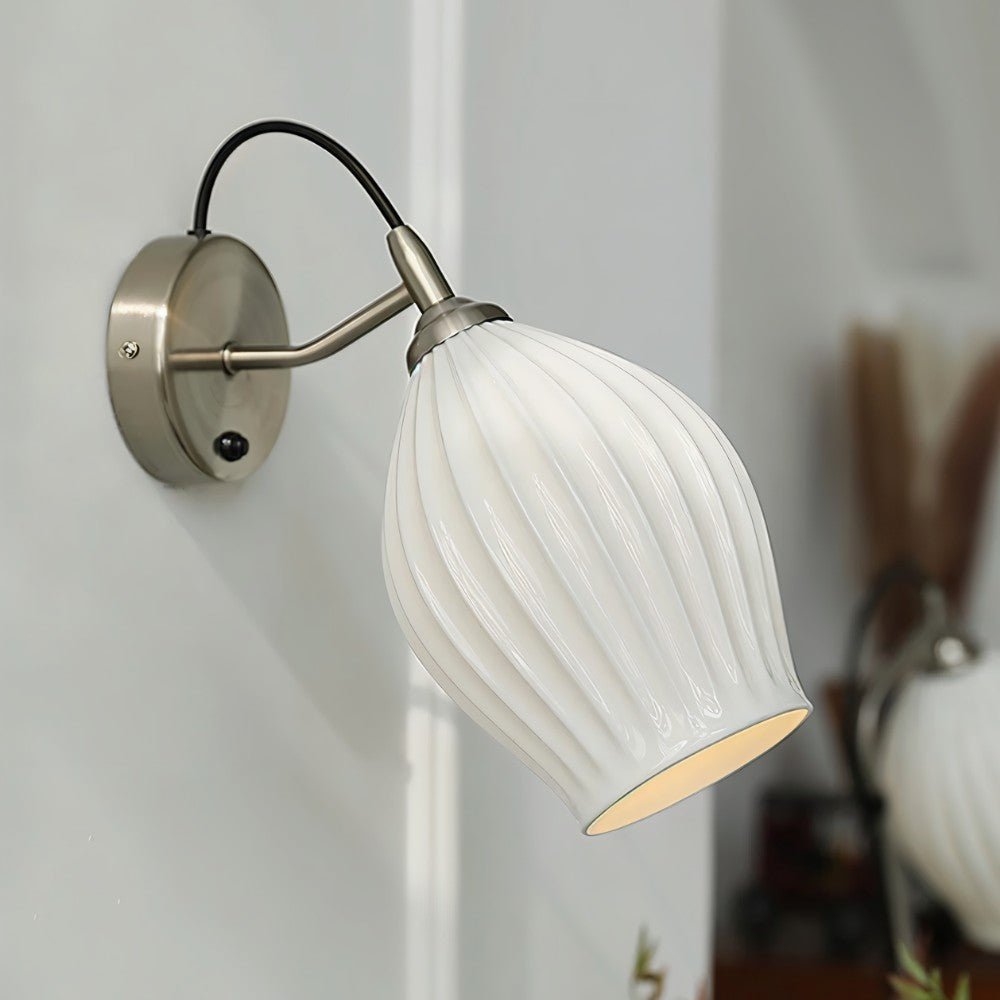 Modern Haela Wall Lamp by Residence Supply with sleek metal finish and integrated LED lighting, mounted on a white wall.