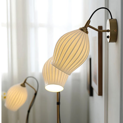 Modern Haela Wall Lamp by Residence Supply with a sleek metal finish and minimalist design, mounted on a plain wall.