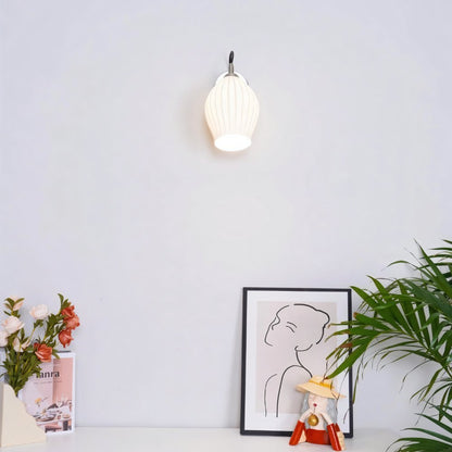 Modern Haela Wall Lamp by Residence Supply featuring a sleek design and warm light, mounted on a wall for stylish illumination.