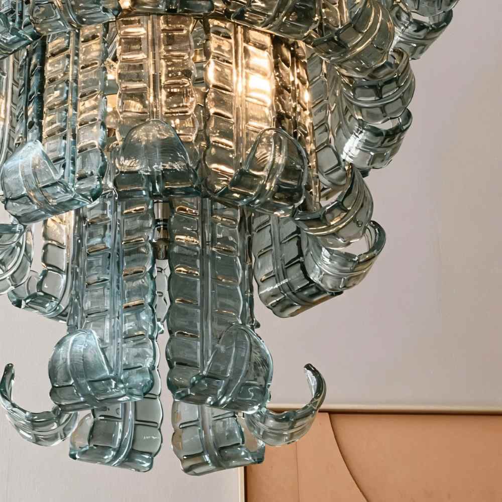 Halan Chandelier by Residence Supply featuring tiered glass design with intricate glass details and elegant lighting.