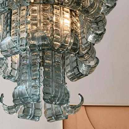 Halan Chandelier by Residence Supply featuring tiered glass design with intricate glass details and elegant lighting.