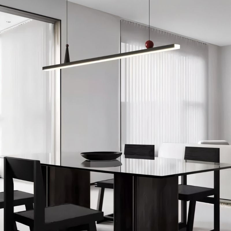 Residence Supply Halrya pendant light hanging above a dining table with a sleek, modern linear design.