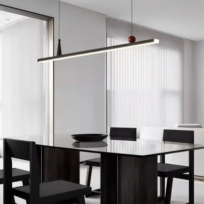 Residence Supply Halrya pendant light hanging above a dining table with a sleek, modern linear design.