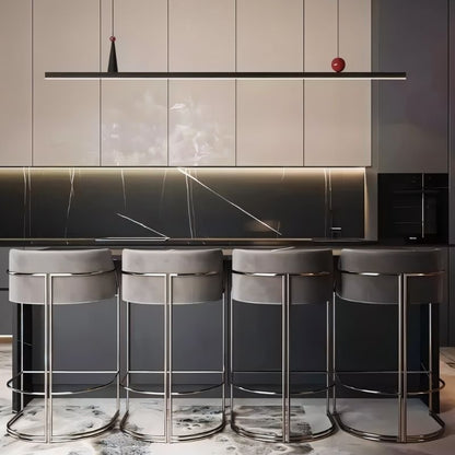 Residence Supply Halrya pendant light hanging above a kitchen island, featuring a modern design with sleek metal finish.
