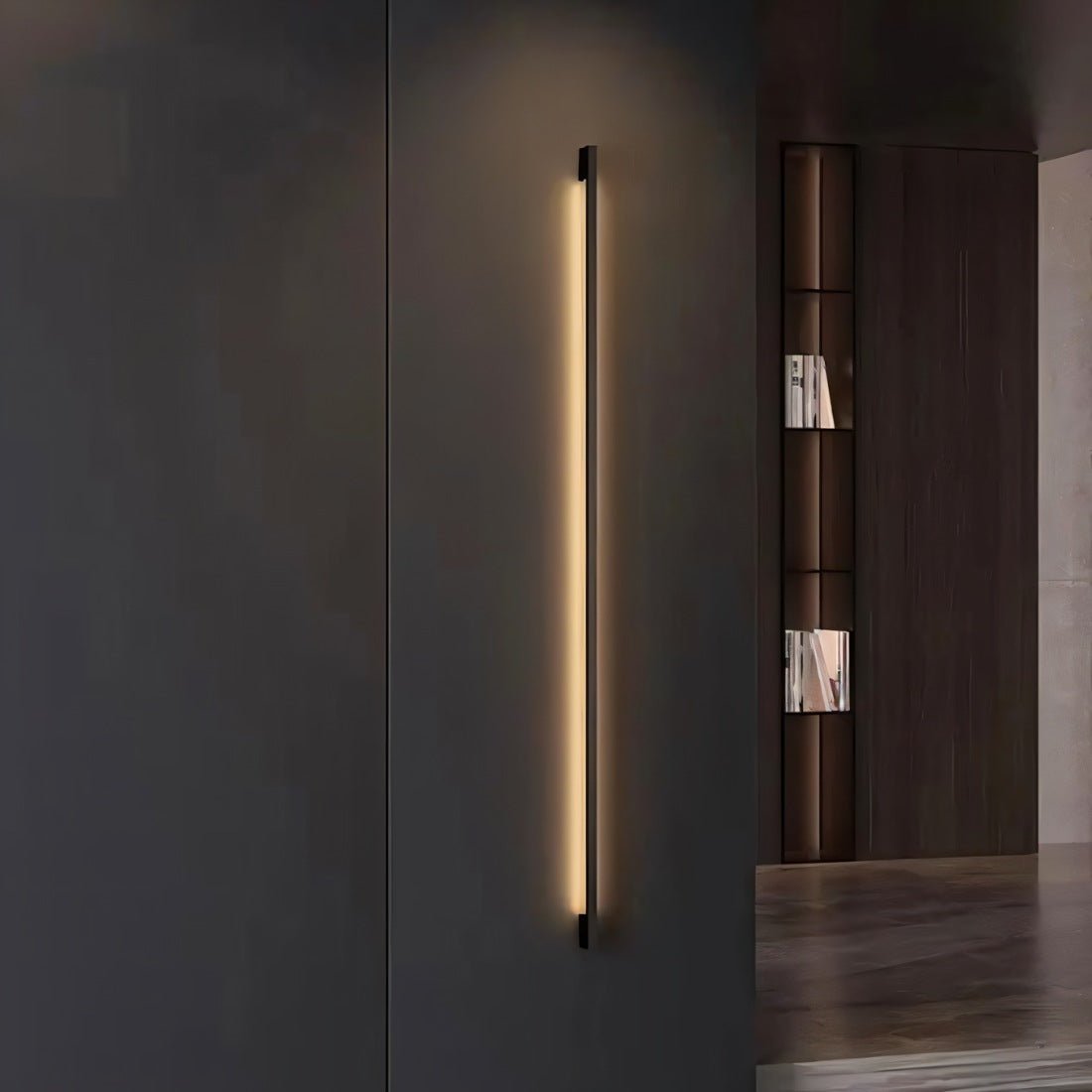 Residence Supply Hanur Wall Lamp mounted on a wall with a modern design and warm lighting, ideal for interior decor.