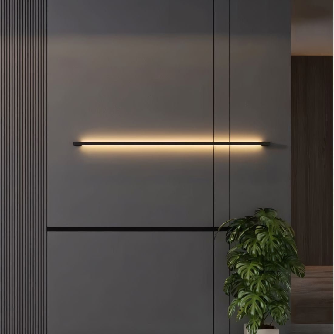 Residence Supply Hanur Wall Lamp shown mounted on a wall with a modern design and warm lighting.