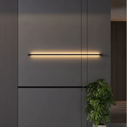 Residence Supply Hanur Wall Lamp shown mounted on a wall with a modern design and warm lighting.