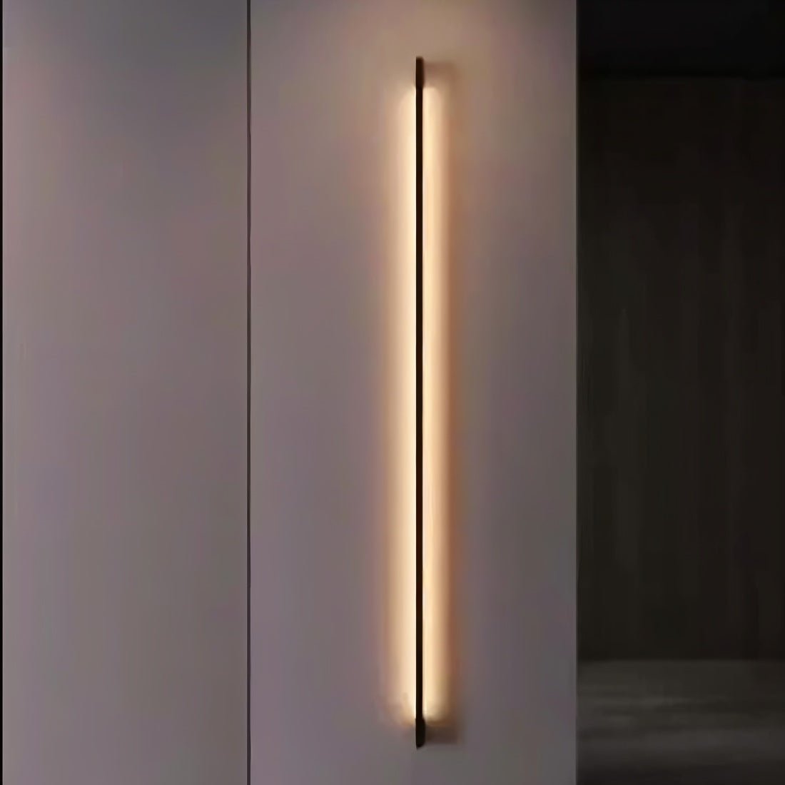 Modern Hanur Wall Lamp by Residence Supply with a sleek metal finish and minimalist design for ambient lighting.