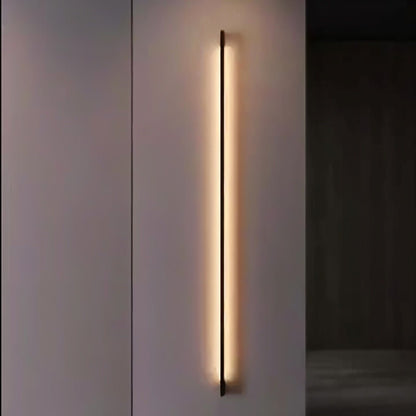 Modern Hanur Wall Lamp by Residence Supply with a sleek metal finish and minimalist design for ambient lighting.
