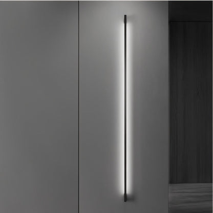 Residence Supply Hanur wall lamp mounted on a wall with a modern design and warm lighting for interior decoration.