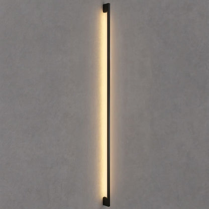 Modern Hanur Wall Lamp by Residence Supply featuring a sleek metal design and warm lighting for contemporary interiors.