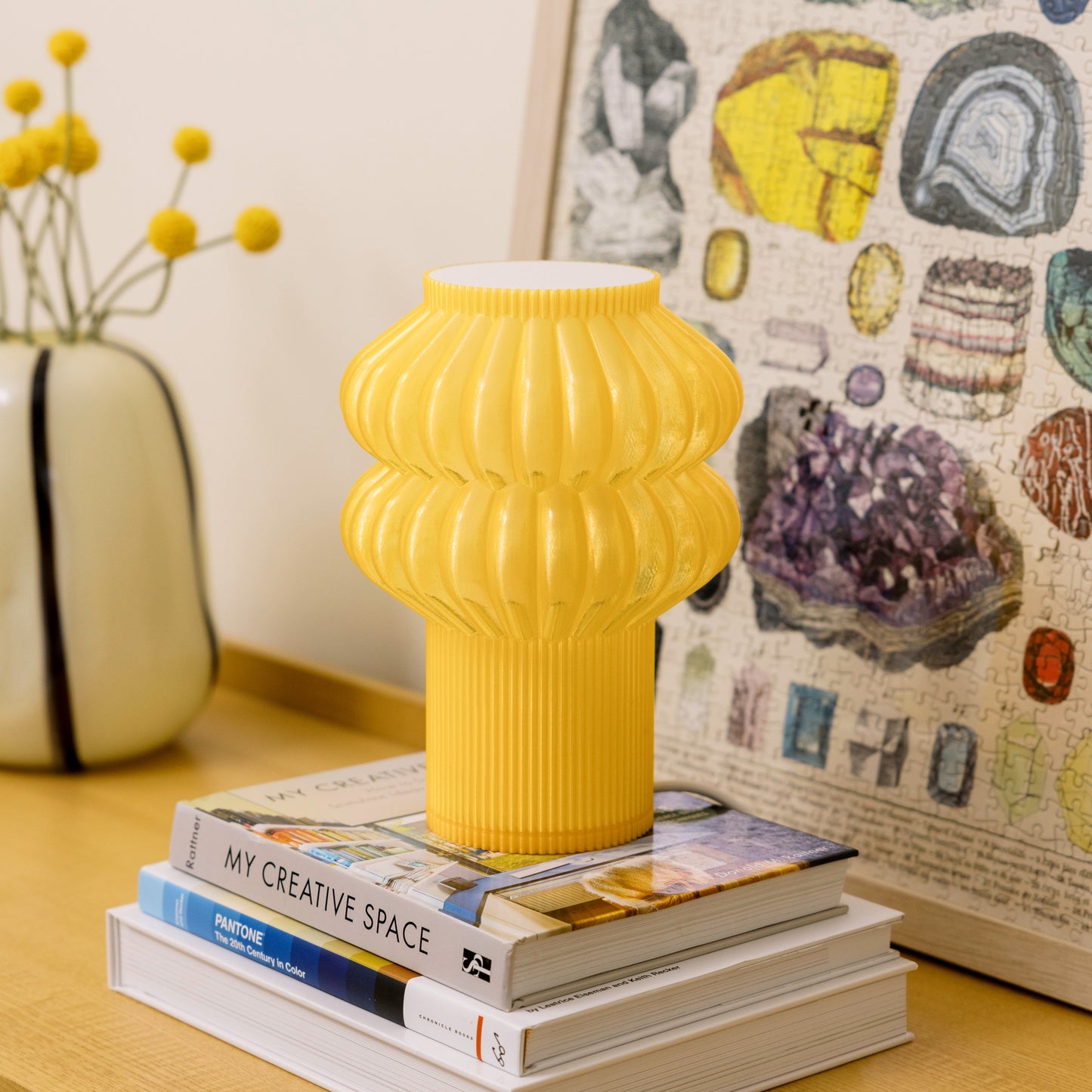 Terra Labs Oppi Table Lamp with honey-colored ceramic base and white fabric shade on a wooden table.