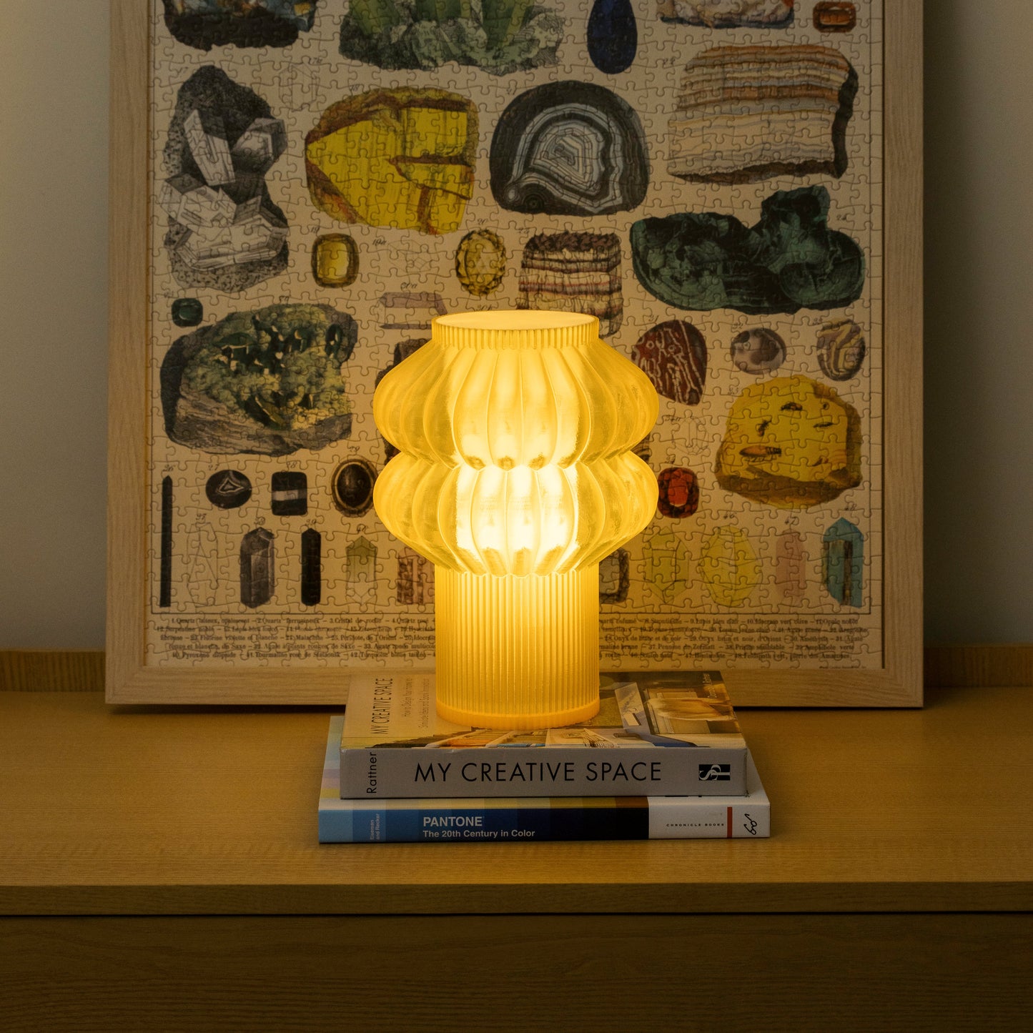 Terra Labs Oppi Table Lamp with honey-colored ceramic base and white fabric shade on a wooden surface.