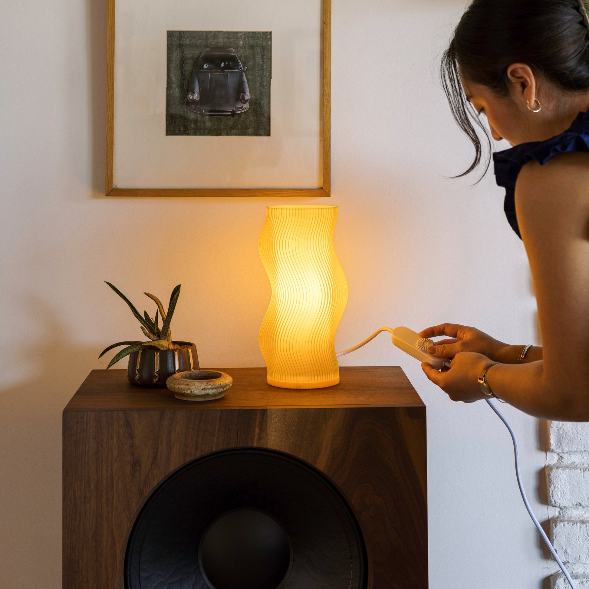 Terra Labs Honey Woogie Table Lamp with a warm, honey-colored ceramic base and a neutral fabric lampshade.