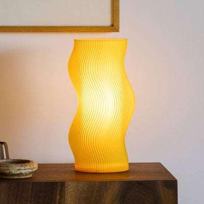 Terra Labs Woogie Table Lamp with a honey-colored ceramic base and a white fabric shade, stylish home lighting.