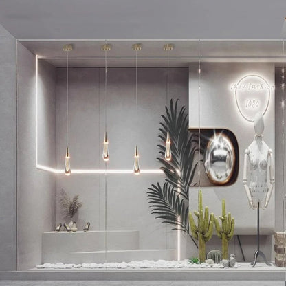 Drop Linear Chandelier by Residence Supply featuring sleek, modern design with multiple hanging lights and a minimalist metal frame.